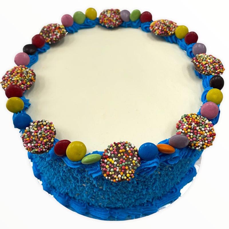 This colourful cake is iced in real fresh cream, rolled in blue sprinkles, with blue buttercream borders and finished with smarties and freckles!
