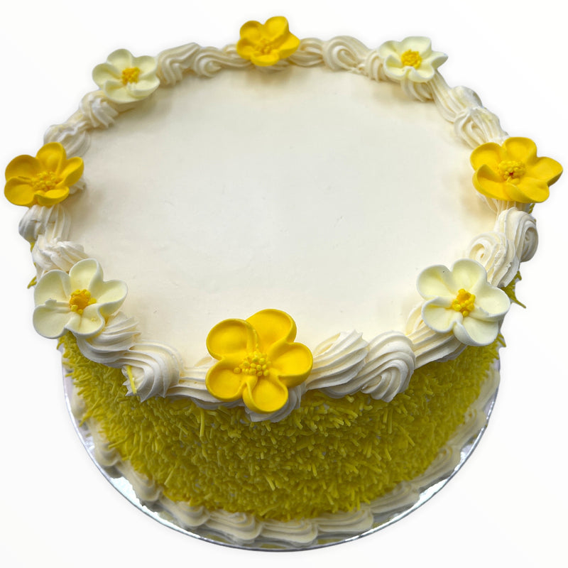 This classy cake is iced in real fresh cream, decorated with yellow sprinkles, fresh cream borders and finished with white and yellow sugar flowers!